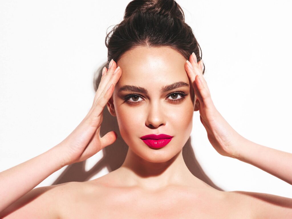 fashion beauty portrait young brunette woman with evening stylish makeup perfect clean skin sexy model with hair bun posing studio with pink bright natural lips isolated white min